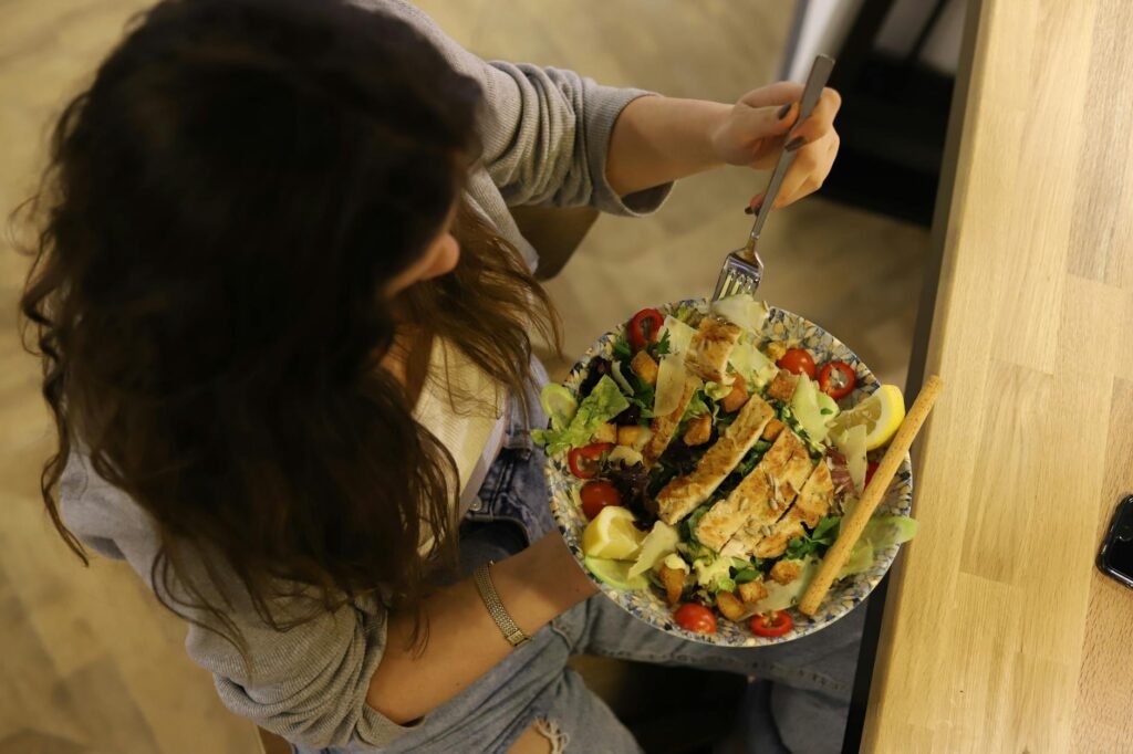 A chicken salad topped with a modest measured portion of avocado