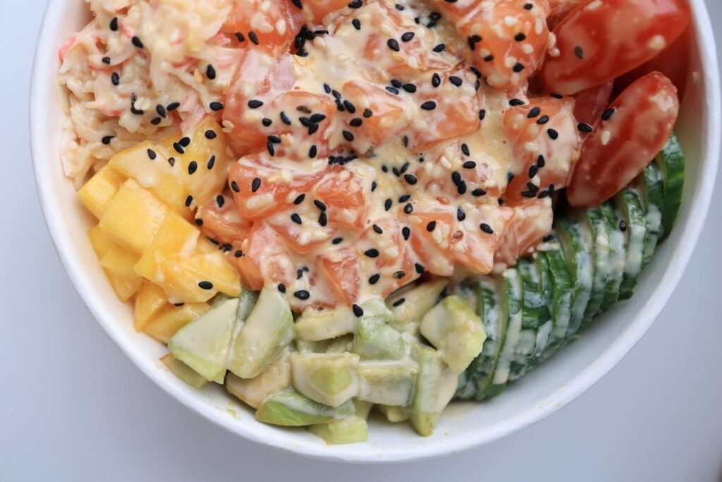 Two high-protein avocado meal bowls with vegetables on a table
