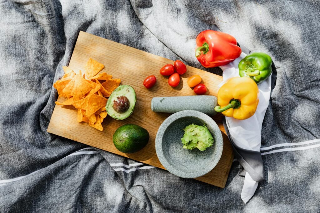 Ingredients for one batch of avocado sauce arranged neatly on a cutting board
