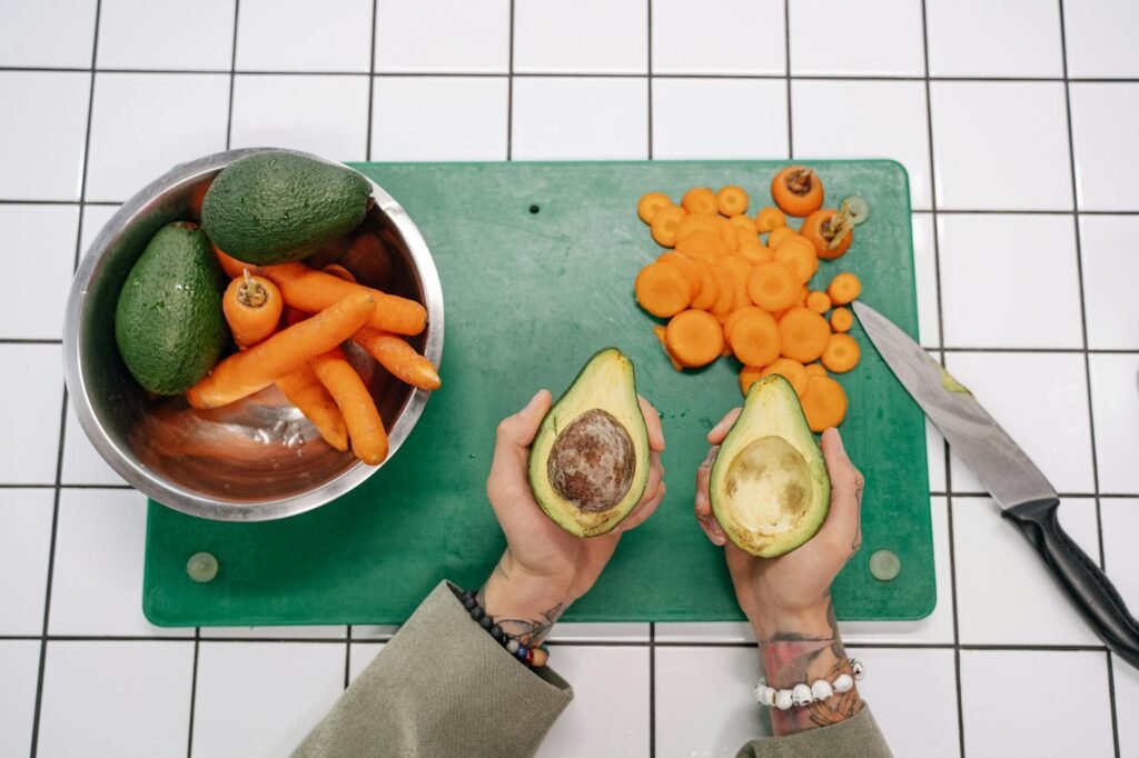 A measured portion of avocado beside a lunch bowl on a kitchen scale