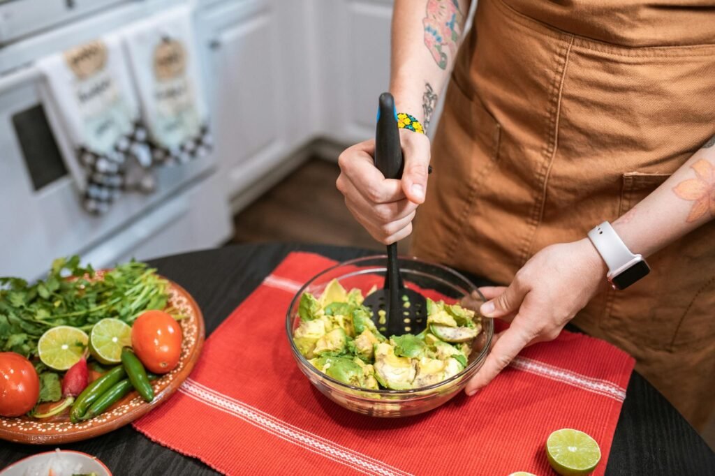 A small bowl of mashed avocado being portioned for a meal
