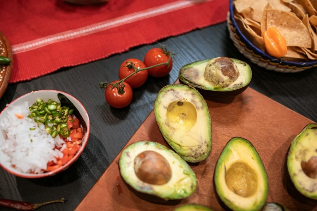 Two avocado halves on a board showing ideal ripe texture versus overripe texture