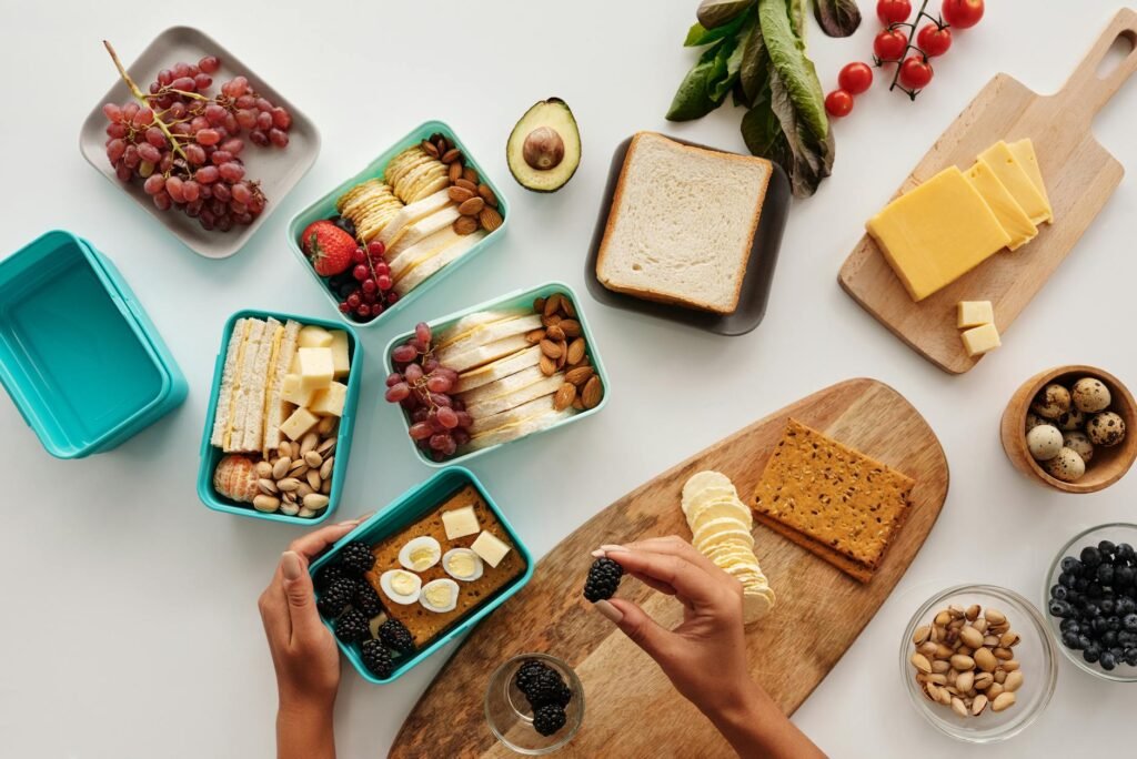 Meal prep ingredients with avocados, greens, beans, and chopped vegetables