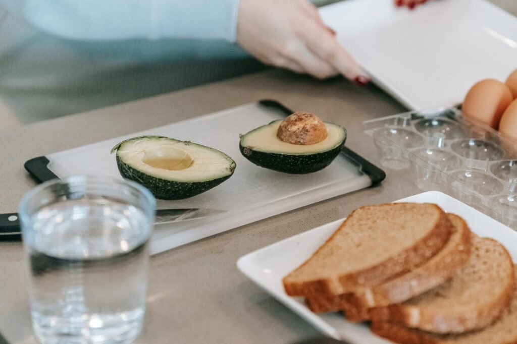Overhead view of a grocery receipt beside avocados, bread, eggs, and lemon