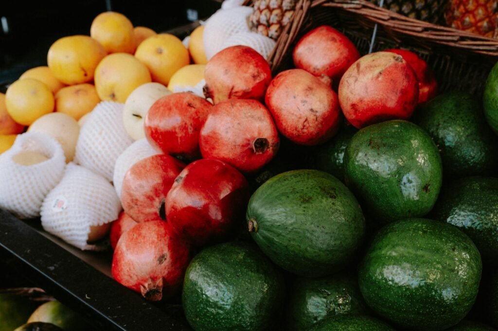 A tidy refrigerator shelf with ripe avocados, lemons, and small labeled leftover containers.