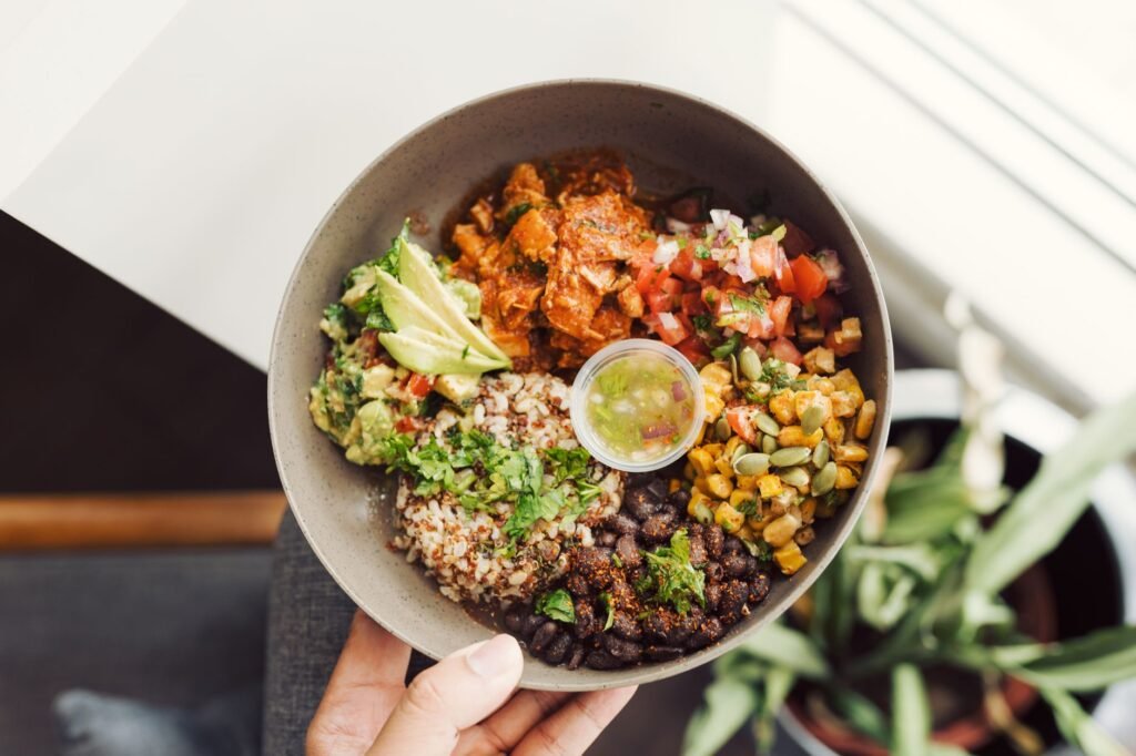 Grain bowl with avocado, beans, vegetables, and whole grains viewed from above