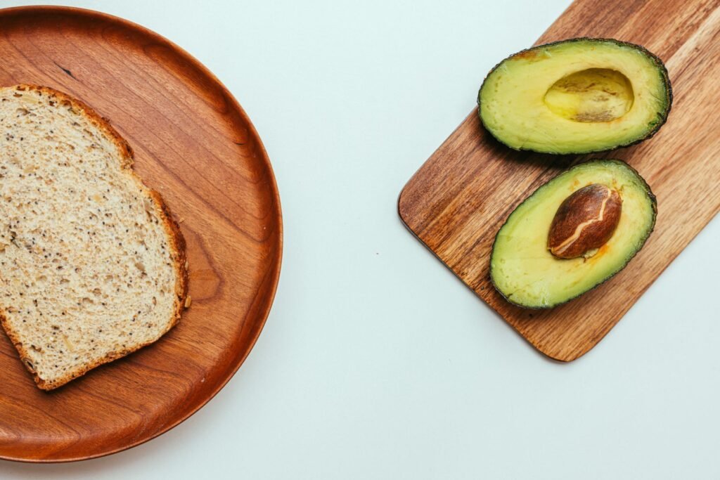 Several avocados in visibly different ripeness stages on a countertop